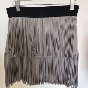 Grey Fringed mini skirt with elasticized waist and exposed back zipper. Size 2